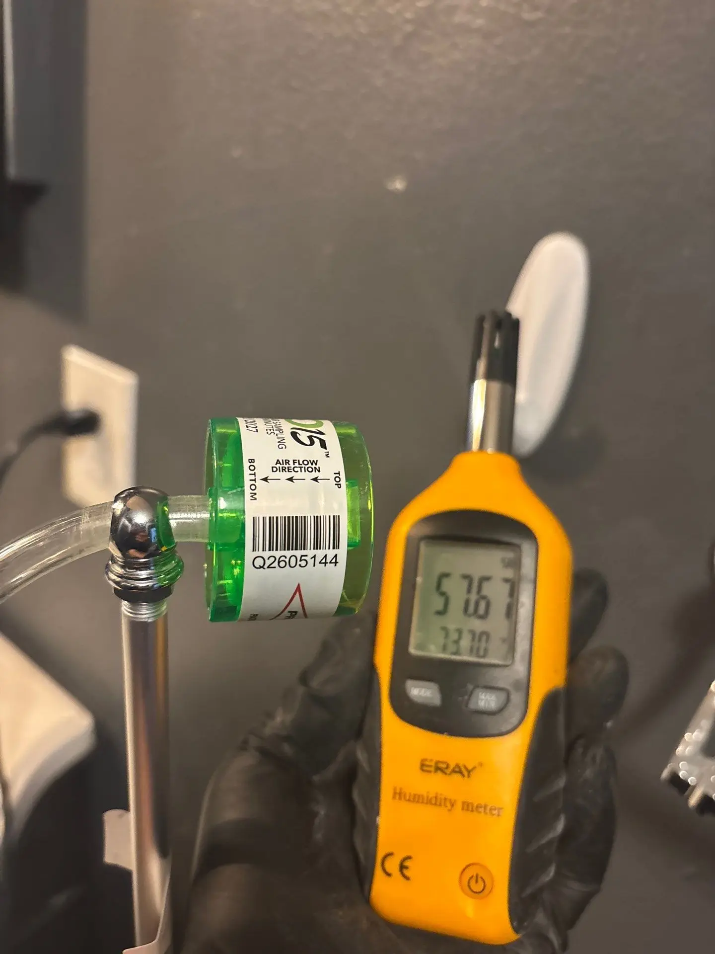 Professional air quality testing equipment and mold sampling cassette used by certified inspectors in Miami and Orlando